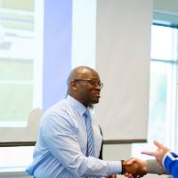 panelist shake hands with listeners